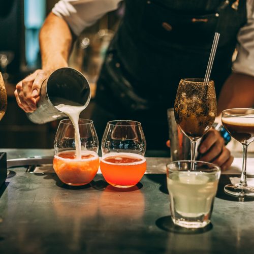 The bartender making an alcoholic cocktail, a summer cocktail in the bar